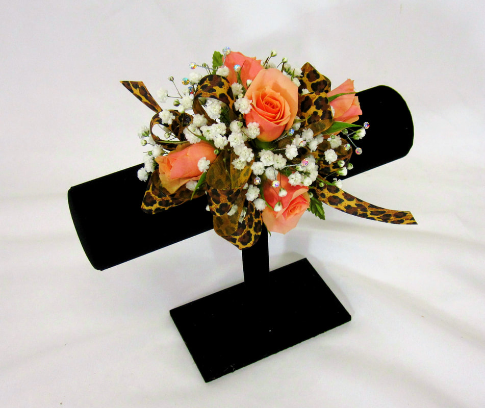 Coral rose corsage with cheeta ribbon