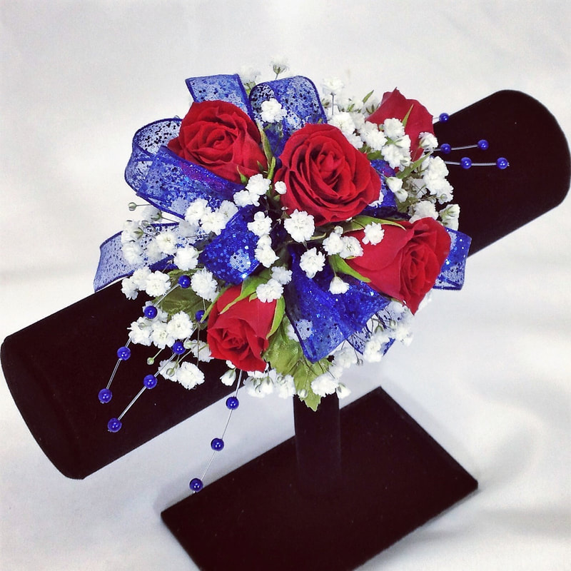 Red rose corsage with royal blue bow