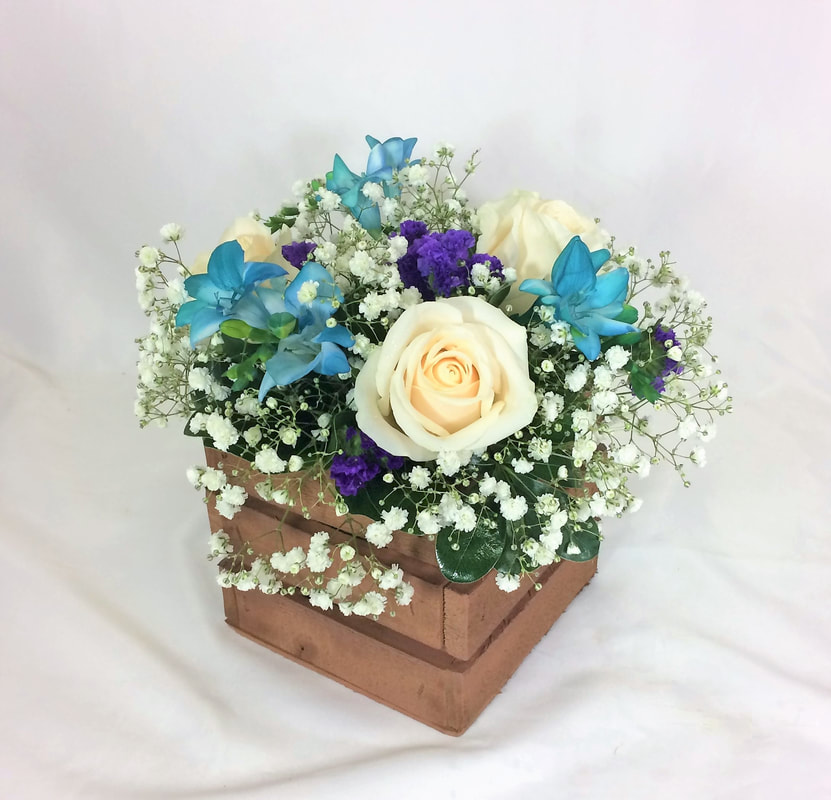 White rose and Freesia Centerpiece in crate