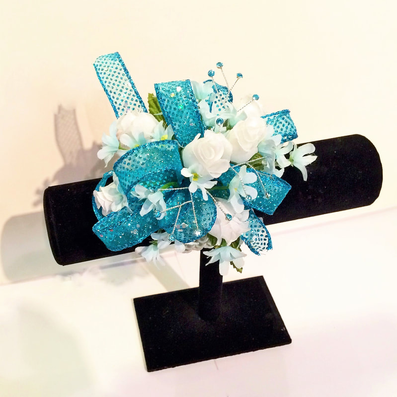 White rose wristlet with sparkly teal bow