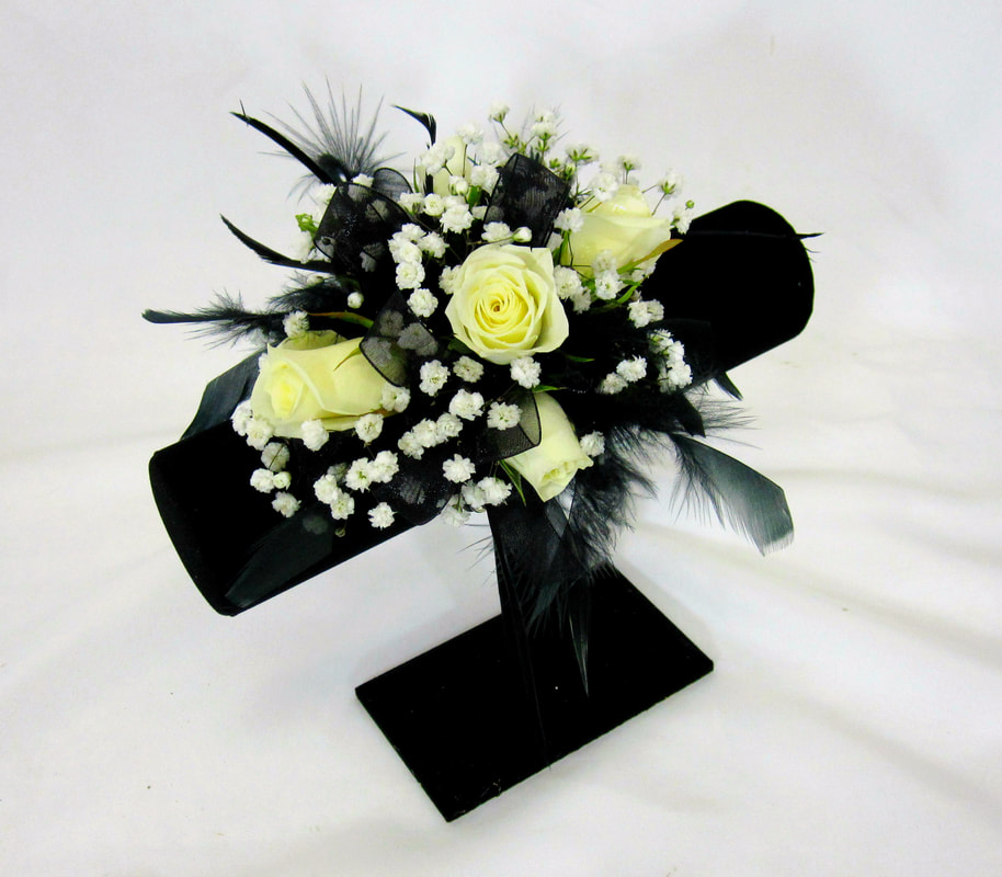 White rose wristlet with black feathers