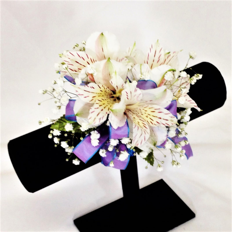 White Alstro corsage with Periwinkle Bow