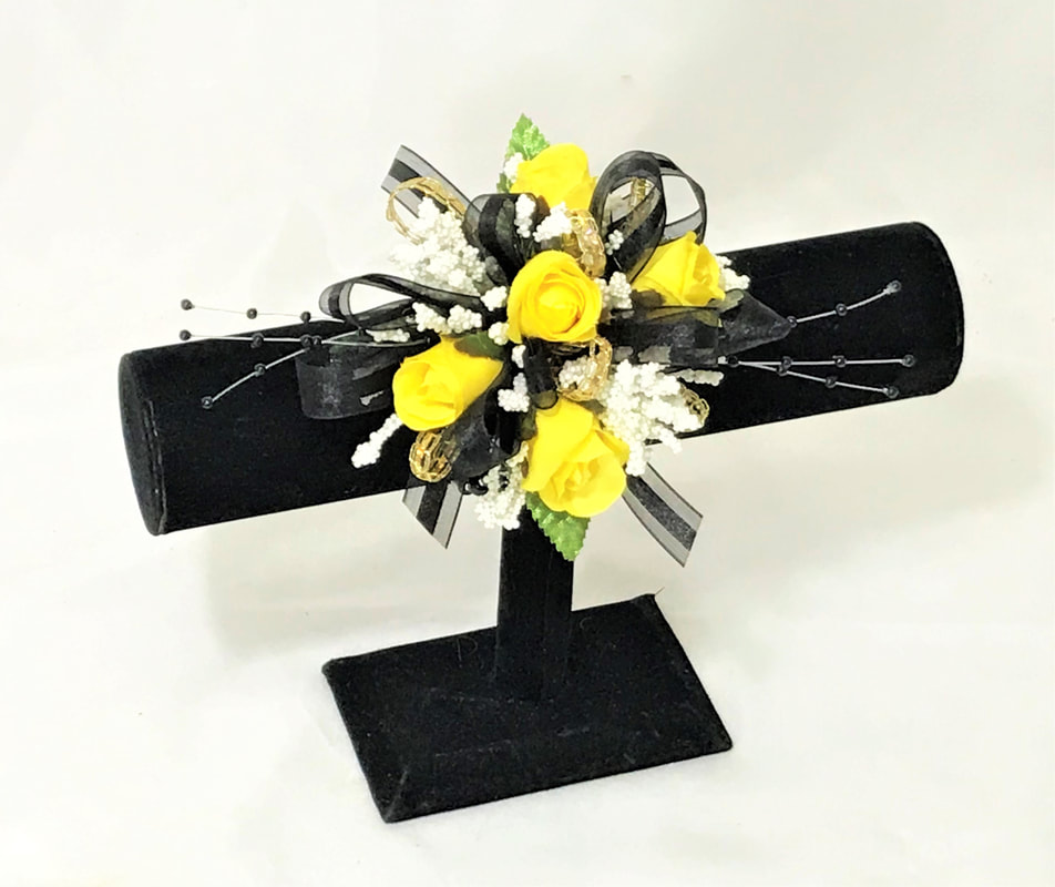 Yellow rose wristlet with black ribbon