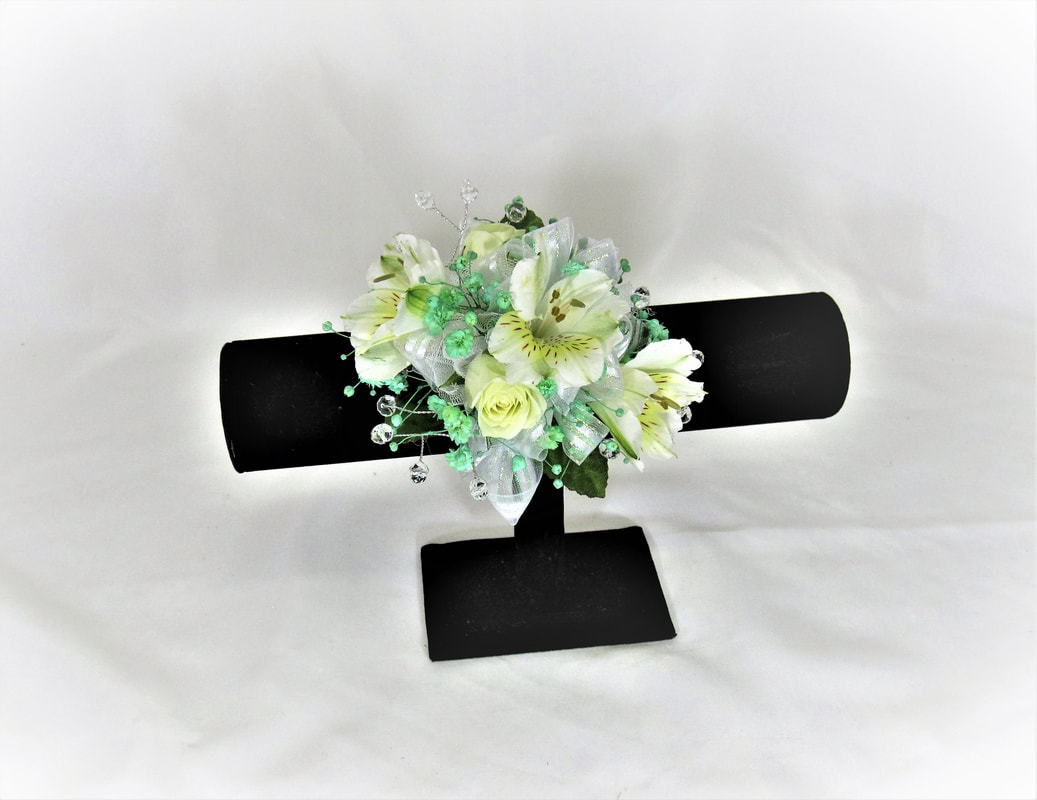 White alstro corsage with mint babies breath